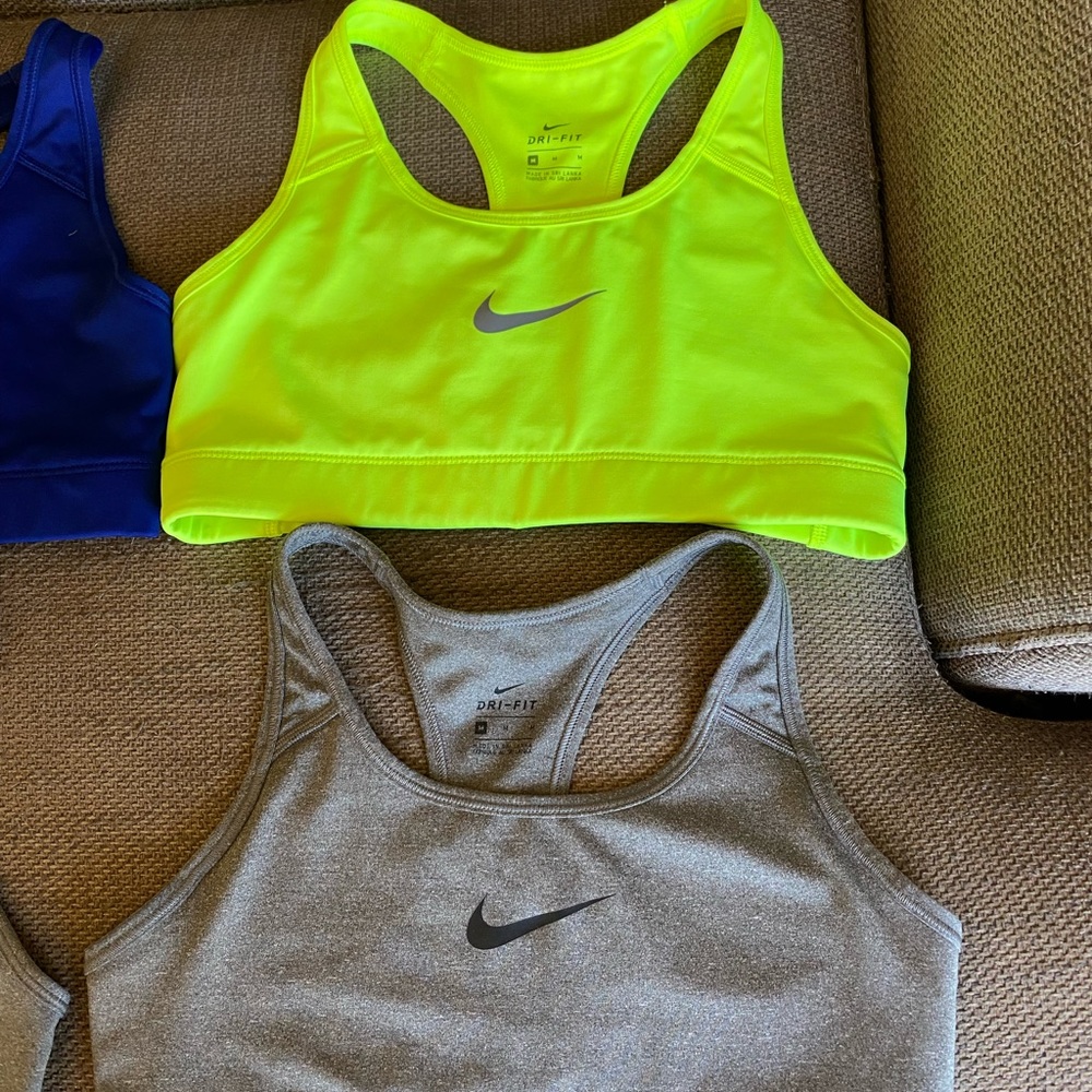 Nike women sports bras. Size medium. EUC. One purple, one gray and one yellow.